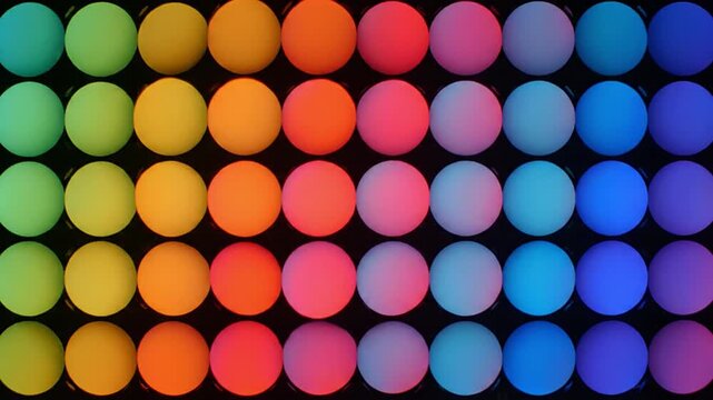Abstract pattern of glowing colorful circles animating on a digital display, creating a vibrant rainbow gradient. Ideal for technology backgrounds, data visualization, modern design, and creative...