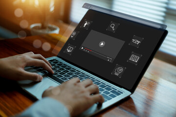 Business professional using online video learning platform on laptop for digital education, remote training and multimedia courses. Modern interface for e-learning, skill development. © wasan