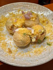 Traditional Indian Street Food Dahi Puri Chaat with Yogurt and Sev © Chayan