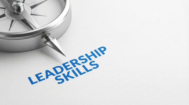 Silver compass pointing towards the text leadership skills on a white background representing business direction and guidance.