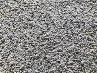 Close-up texture of a rough grey pebble dash wall © Moon Side