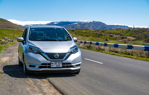 Modern silver vehicle on scenic mountain highway