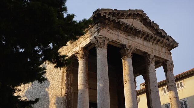 Pula, Croatia - August 17, 2025: The Temple of Augustus in Pula features majestic Corinthian columns and weathered stone under soft evening light