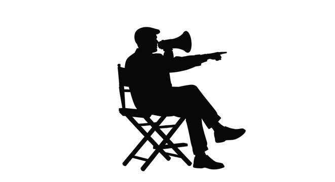 A film director gives instructions while seated captured in striking silhouette