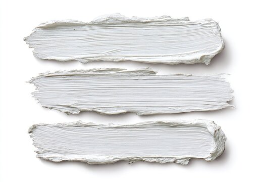 Three textured white paint strokes with visible brush marks on a plain background
