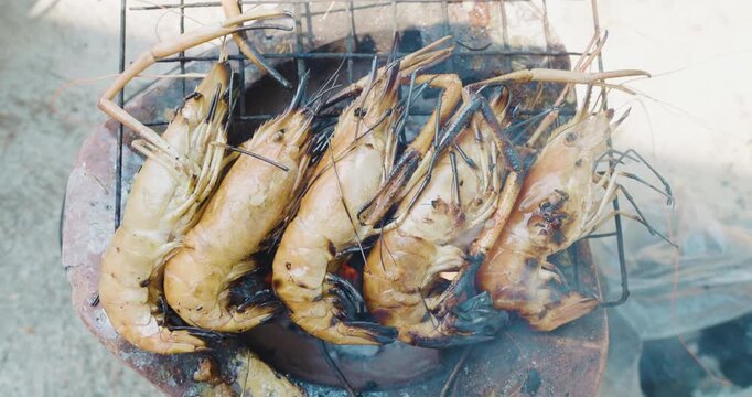 Grilled river prawn shrimp on fire smoke seafood