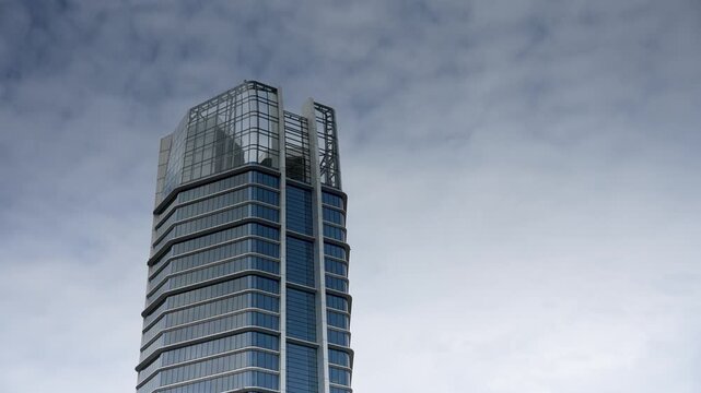 Modern Architecture of Budapest Hungary Featuring the MOL Campus Skyscraper Against a Cloudy Sky with Smooth Zoom Out Camera Motion