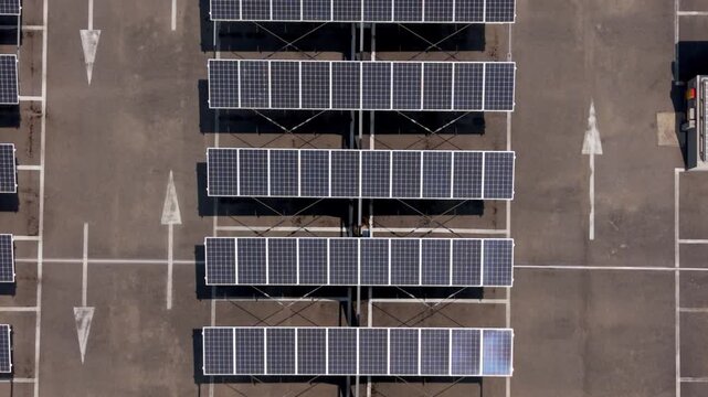 Solar Panels Over Car Park: A high-angle perspective showcasing a car park elegantly shaded by rows of solar panels, capturing the modern fusion of sustainability and practical design. 