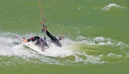 Kitesurfer crashing into water with splash, extreme sport action moment © karamysh