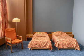 A room in the Kosmos Hotel, built for the Olympic Games-80 in Moscow. A historic room with a view of the VDNKh at the Kosmos Hotel. Retro interior in the hotel. Beds in the Cosmos Hotel room.