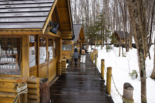 Asian mother and son travel. Traditional village. asian fat mother and family tourist Visiting in Furano, Traveler in Sweater sightseeing Ningle Terrace Cottages. landmark for attractions in Hokkaido