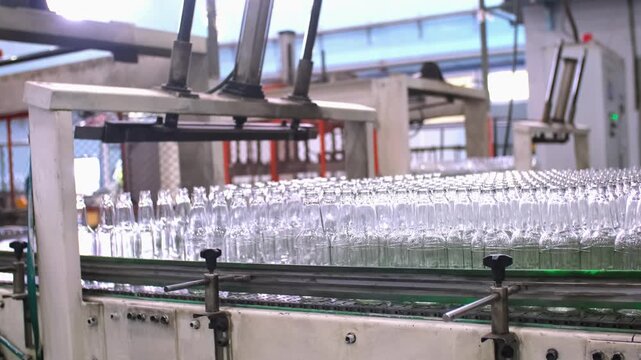 Glass factory, production of glass containers. Packaging of food containers. Robotics in industry. Modern technologies, robotic machines produce products. Technological work at the plant.