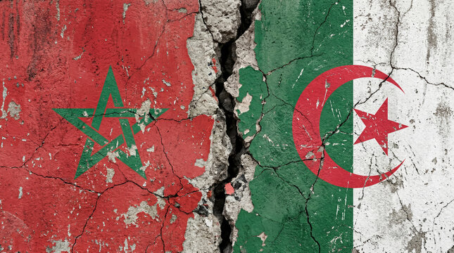 A cracked and weathered wall displays the flags of Morocco and Algeria, symbolizing tension and conflict between the two nations.