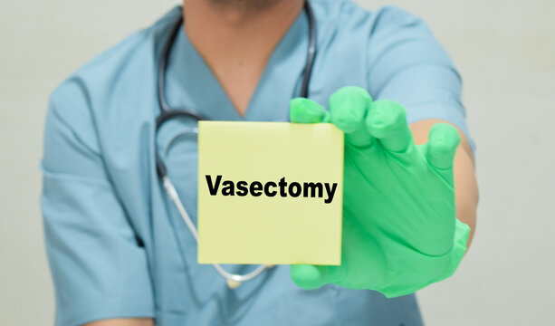 Doctor holds in hands a card with the name of the vasectomy. Medical concept