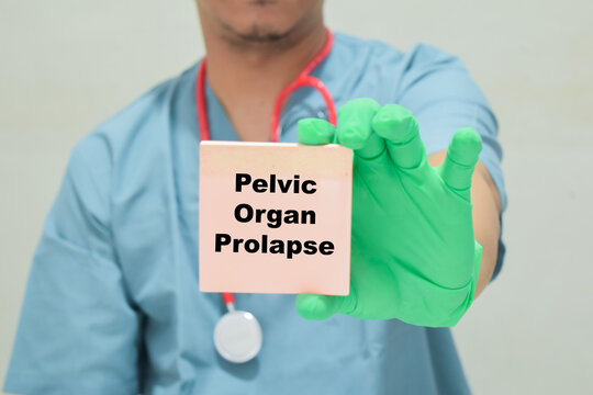 Doctor holds in hands a card with the name of the pelvic organ prolapse. Medical concept