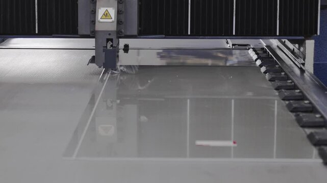 The machine is notching aluminum composite panels in the factory.