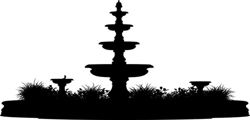 Obraz premium Multi tiered garden fountain silhouette surrounded by plants