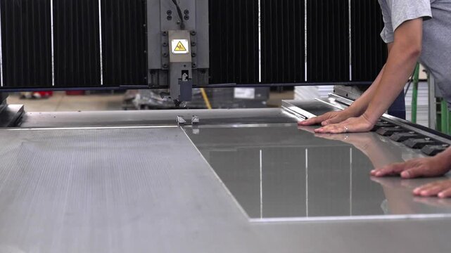 The machine is notching aluminum composite panels in the factory.