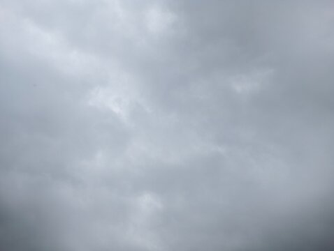 A dramatic view of a grey overcast sky filled with heavy storm clouds.
