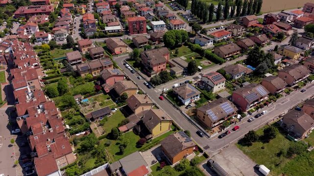 Aerial view of suburban houses in Bellaria, Milan, Italy with solar panels on rooftops. Residential infrastructure generating renewable energy and supporting sustainable urban development and ESG stra