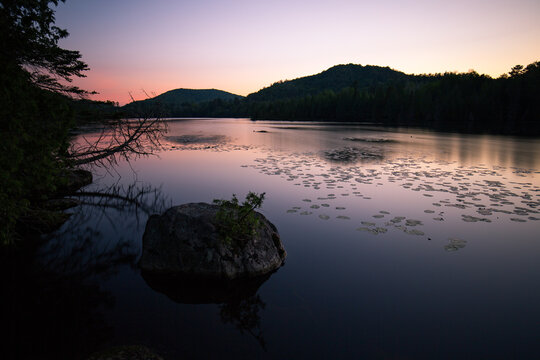 Sunset lake view in Sainte Adele Quebec with shoreline and mountains