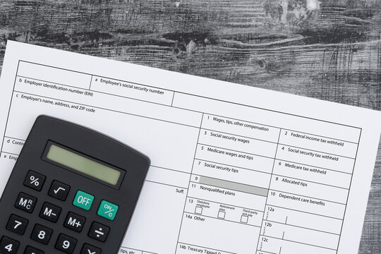 W2 tax form with calculator for tax filing