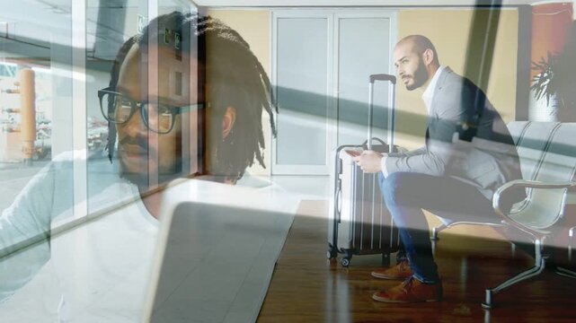 Overlay superimposing laptop over traveler while man typing and man checking phone at gate, waiting