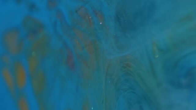 Vertical video. Fog fluid. Blur color mist. Blue paint liquid explosion wave on yellow red background. Sparkling art smoke underwater abstract spilling.
