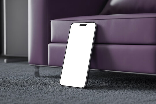 A smartphone with a blank screen leans against a purple leather couch in a modern living room