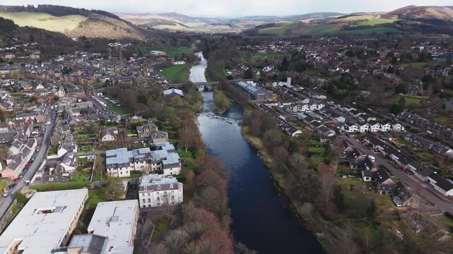 Panoramic view of the River Tweed winding through the ancient town of Peebles surrounded by the lush green hills of the Scottish Borders.