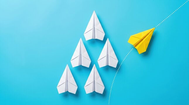 Yellow paper airplane breaking away from a group of white planes to represent leadership and innovation concept