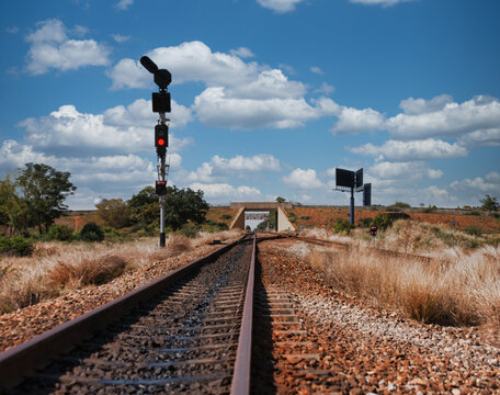Railway Tracks and Signal with Flyover Bridge in Gaborone trackside signal with a red light and black semaphore