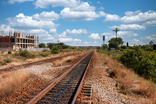 Railway Tracks Beside Building Under Construction in Gaborone multi-story concrete building is under construction,