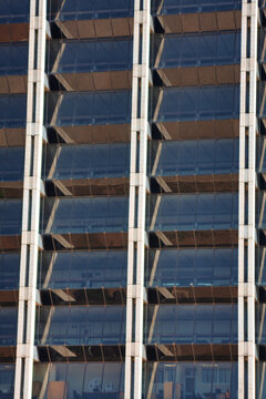 Modern Glass Facade of Office Building with Interior View office interiors with desks and equipment