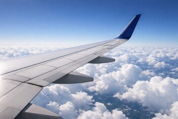 Fototapeta premium Jet wing floating over pristine cloud layers in clear sky