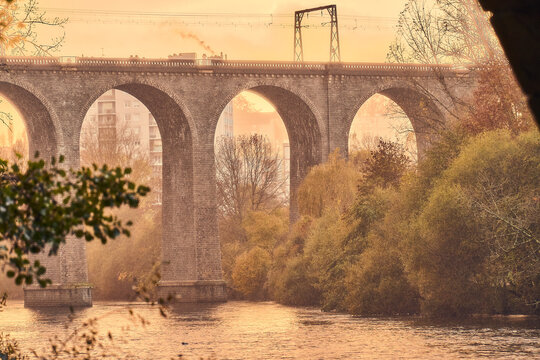Ancient Stone Arched Bridge Over River in the Mist
