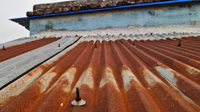 Old rusty metal roof texture with weathered surface, industrial background concept, corrosion and decay theme, vintage structure detail, 8K high quality footage