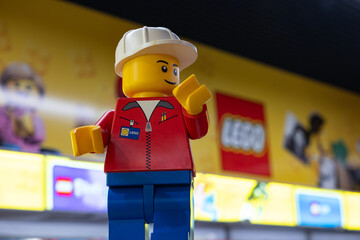Obraz premium LEGO worker minifigure on yellow display shelf in store