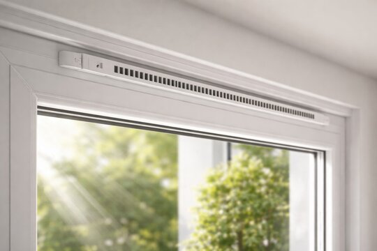 Natural light shining on white PVC window showcasing ventilation fixture in horizontal frame