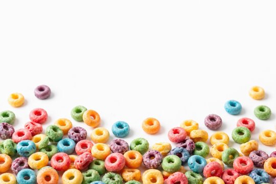 Fruit loops scattered on plain white background with copy space area
