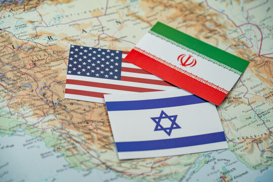 Close up of United States, Israel and Iran flags on map of Middle East region.