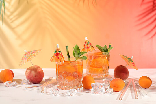 Modern still life with fruits. Royal lemonade cocktail with peach, apricot, mojito with tequila, gin, rum, ice and fresh mint, bar and party concept, restaurant and cafe advertising card