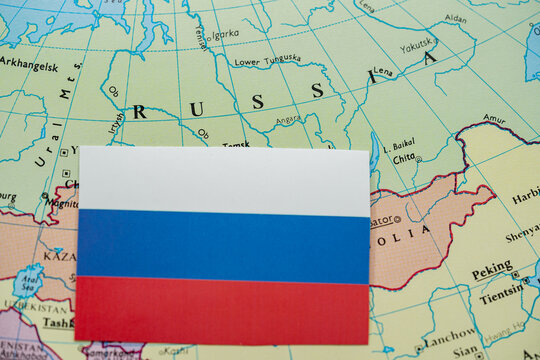 Close up of Russia flag on map of Russia region.