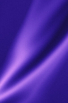 A close up abstract image of flowing rich deep purple satin fabric
