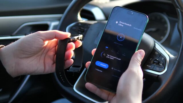 Modern user pairing a Smartwatch Ultra with a smartphone inside a vehicle. High-tech gadget synchronization and mobile app interface. Ideal for wearable technology and smart device promotional videos