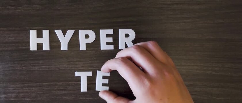 the word hypertension written on a dark background with white block letters or capital letters (fast version)
