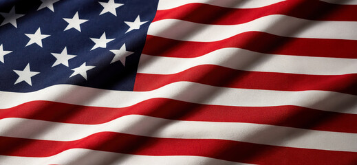 Fototapeta premium The flag of the United States displays its stars and stripes. The fabric shows folds and waves. It is a symbol of national pride and identity. This scene captures its colors and design clearly
