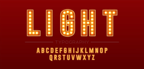 Glowing alphabet typography with light bulbs on red background. Golden retro neon font for headline, signage, poster and display design © Angela Ksen