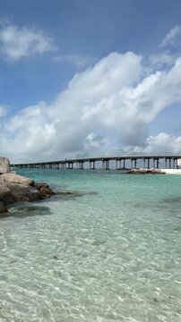 Norriego Beach Point rocky jetties with Destin, Florida bridge view