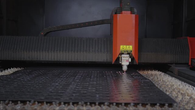 Automated laser cutting machine processing material with precision beam technology, embodying concepts of industrial automation, digital fabrication, and modern manufacturing technology